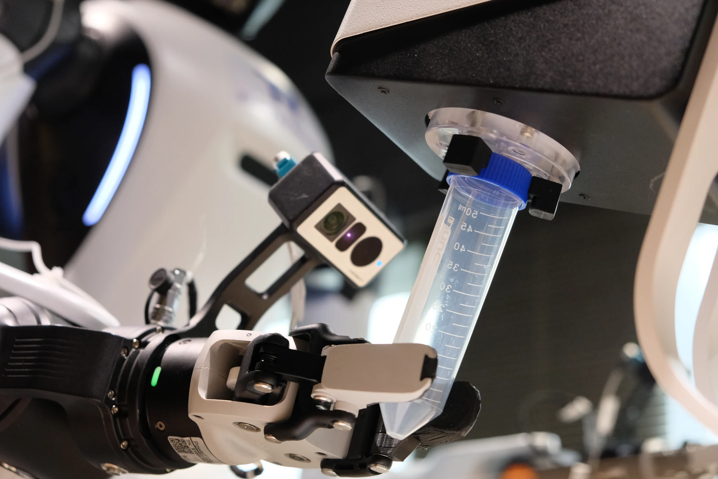 Robotic gripper handling a cell culture vial