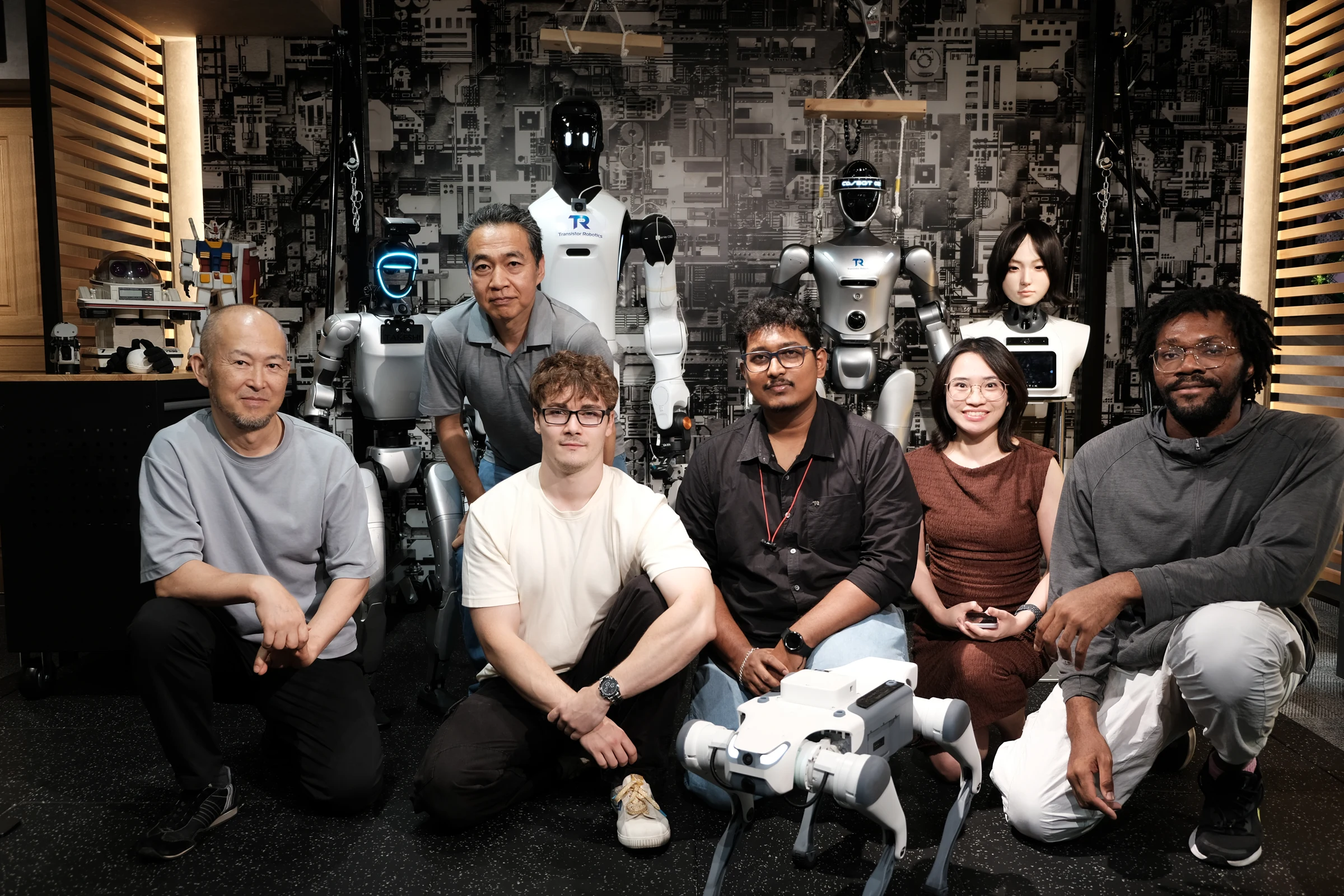 The Transistor Robotics team with humanoid robots in the showroom
